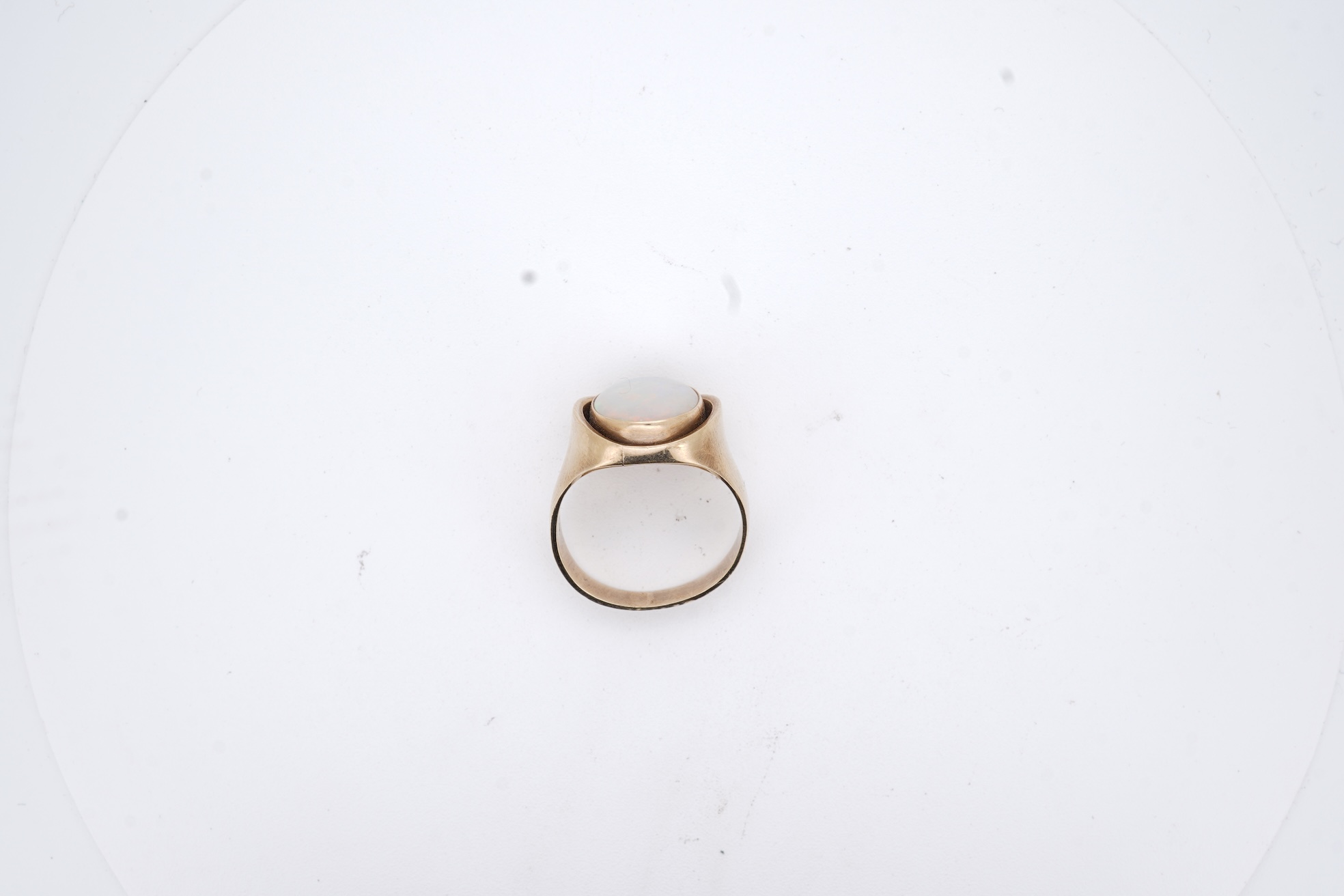 A 9ct and single stone cabochon white opal set ring, size K/L, gross weight 5 grams.